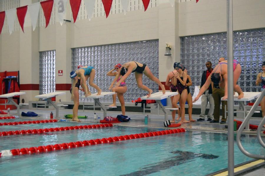 Sophomores+Brontie+Wright+and+Emma+Lattimore+and+junior+Julianna+Sullivan+dive+into+the+pool+during+practice.+Wright+and+Lattimore+are+a+part+of+the+record+setting+relay+team+from+last+year.