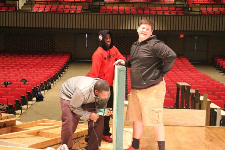 Eric Newton ‘15, Joshua Campbell ‘18 and Stephon Johnson ‘15 hold a platform to put wheels on. This platform was used for the moving sets in the plays.