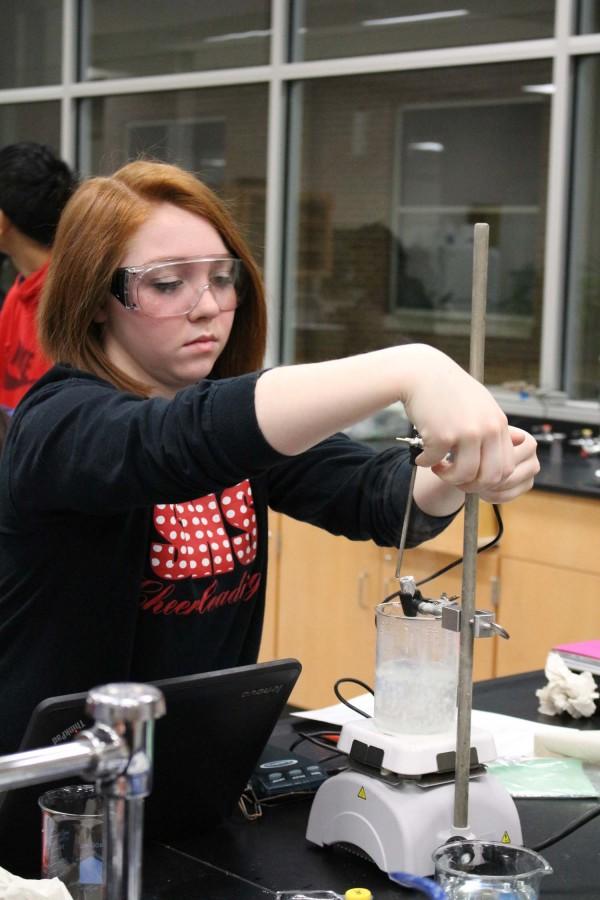 Junior Madison Heath looks at the thermometer to check the temperature for a lab on Jan. 22.