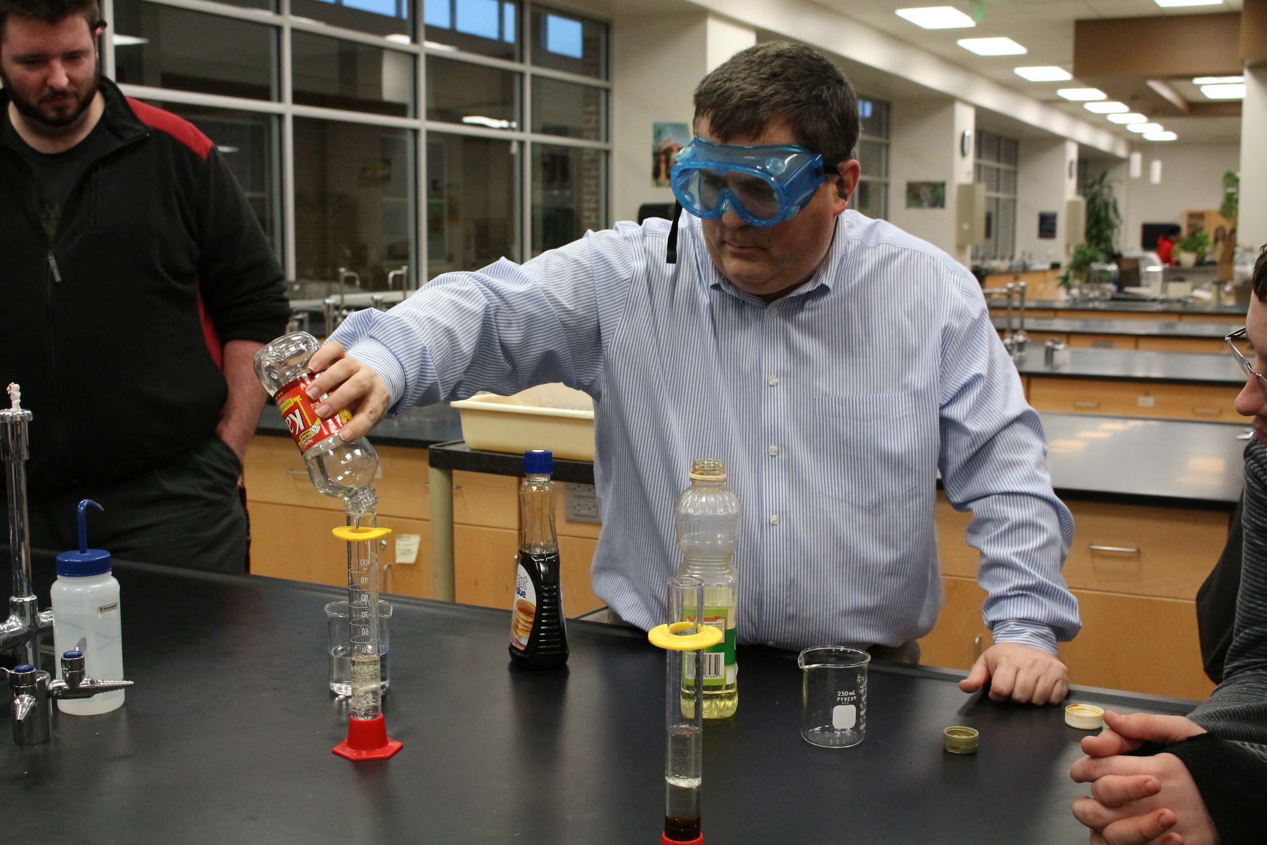 Science teacher Mr. Elmer Sanders mixes together substances to show the differences of density for a chemistry experiment on Jan. 22.