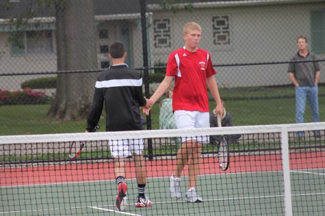 Chase Cawthorne 16 and Adam Coomes 17 high-five each other after scoring a point. Cawthorne and Coomes were double partner. 