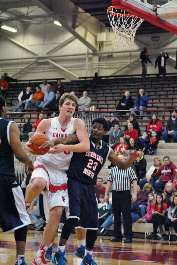 Junior Joey Brunk fights off a defender from Terre Haute North. Brunk had double digit points in the 74-46 rout.