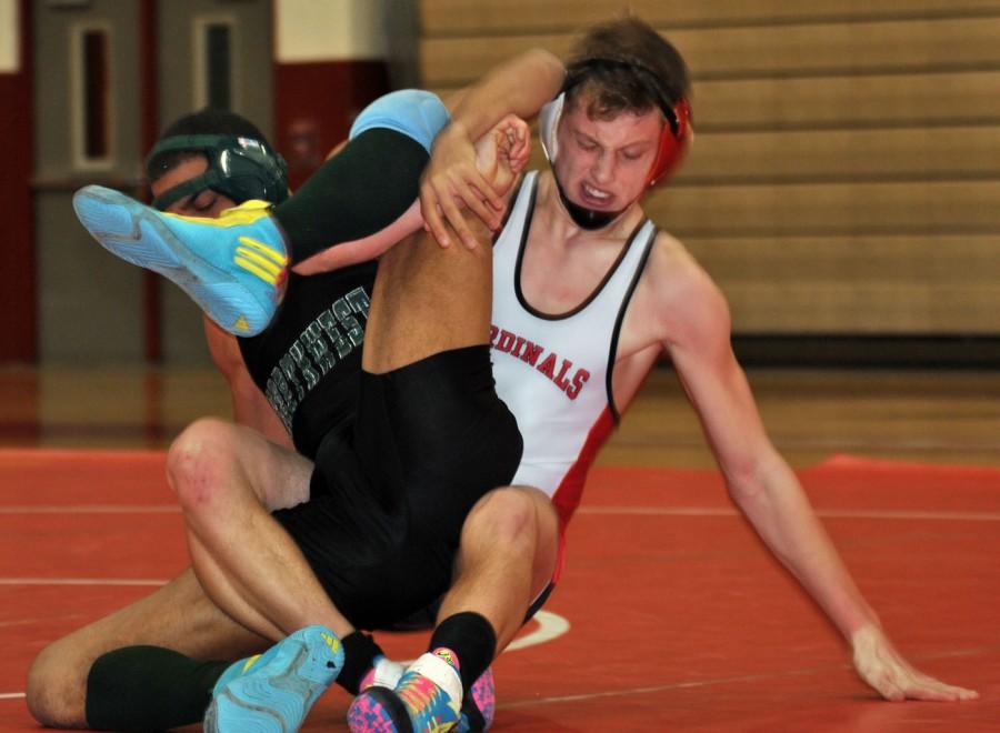 Sophomore Brett Wright pins his opponent on Tuesday Jan. 13. Brett Wright won his match along with 12 other wrestlers.