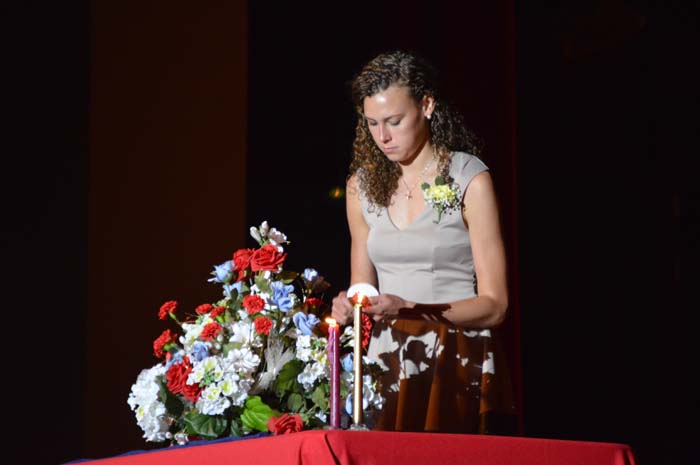 Junior Delaney Bucker lights her candle to signify that she is now an NHS member.
