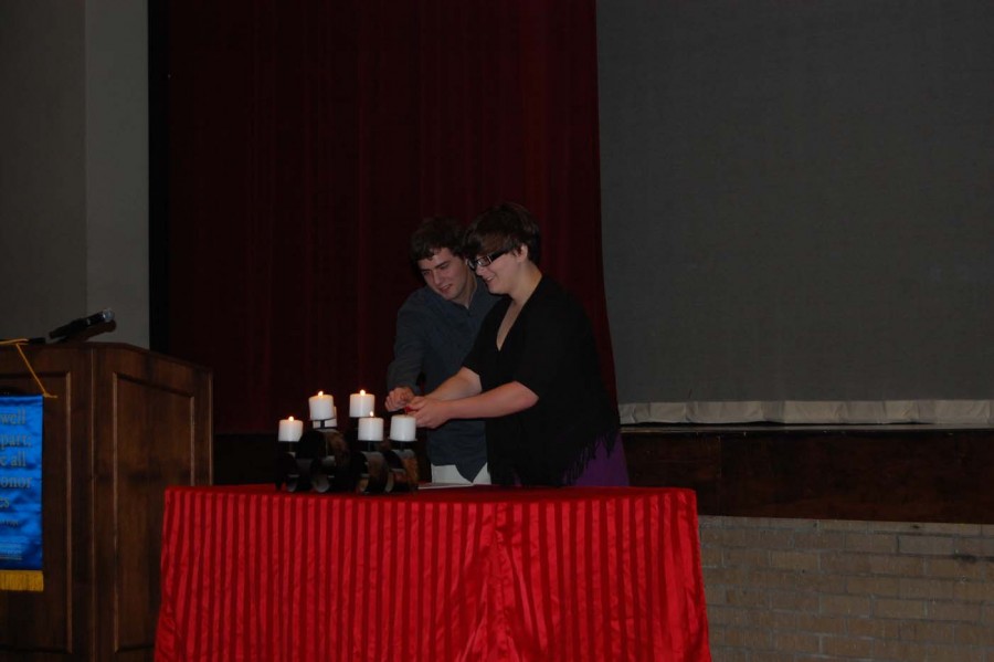 After speaking about dramatic literature, seniors Riley Owens and Cara Locke light the fifth candle as a pair. Owens was one of the 15 students inducted later that day.