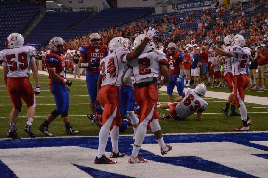 Blake Evans 17 celebrates with his team after scoring a touchdown. Evans earned the Player of the Game award at Lucas Oil.