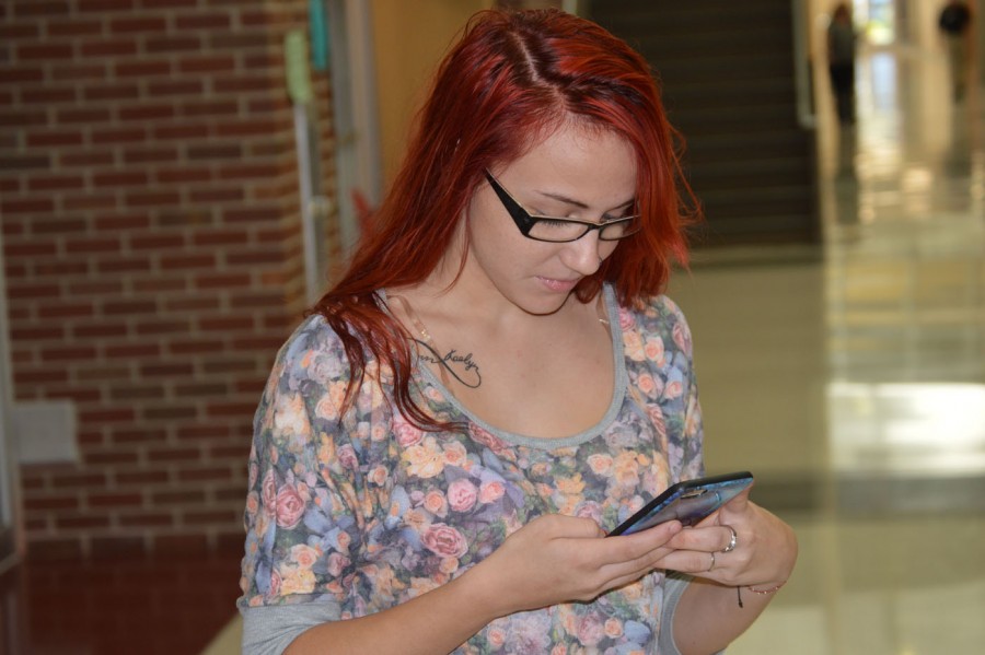 Junior Mikaela Sanders uses social media in the hall on Sept. 29. 