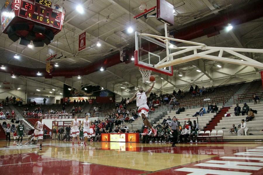 Junior Paul Scruggs throws down a one-handed slam dunk while seniors Joey Brunk and Luke Johnston trail behind. Scruggs,  averaging 14.7 points per game, will shoulder more responsibility at the Marion Classic with Brunk out.  