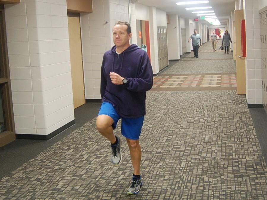 Social studies teacher Nathan Fishel runs down the hallway on Jan. 14. Fishel is committed to running at the least 2 miles every day of 2016, even if he is sick.