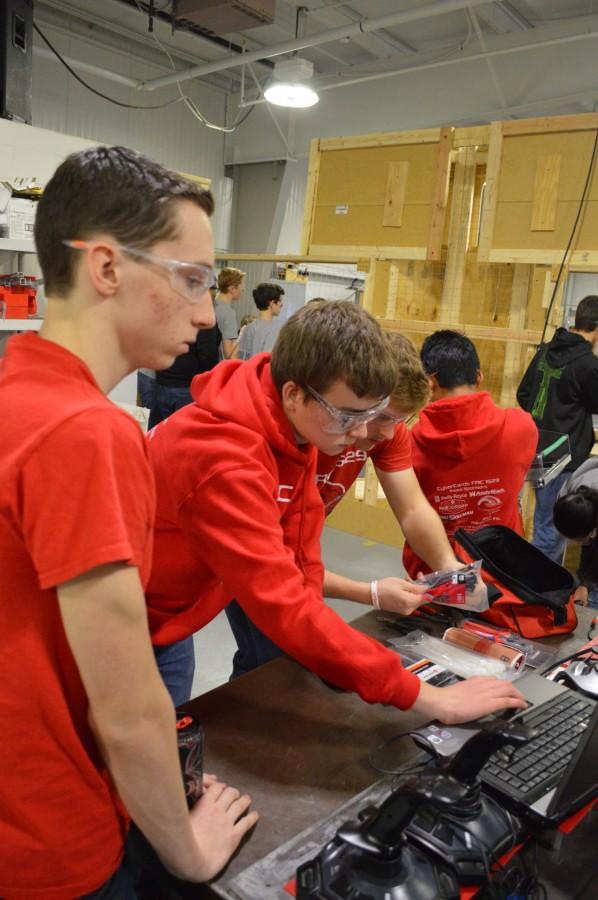 Junior Torey Dunn works alongside a freshman Robotics team member.