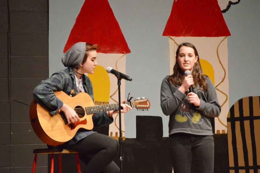 Junior Megan Ferris performs a song live at Coffee House with her friend and supporter, junior Katie Johnson. Singing is a way for Ferris to be outgoing, contrary to her introverted nature. 