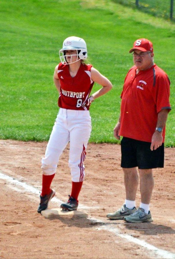 Junior Allie Hicks stands on first base alongside Steve Montgomery during a softball game. Montgomery passed away on May 2.