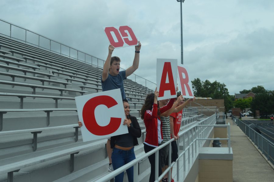 (Left to Right)  Senior Booster Club officers Heather Blankenbaker, Brett Wright, Christy Dean,  Jared Stanley and Michael Phillips cheer on the boys track team last school year.  Students responsible for bringing the other letters skipped out on the event to watch freshly-applied paint dry in the gymnasium. 
