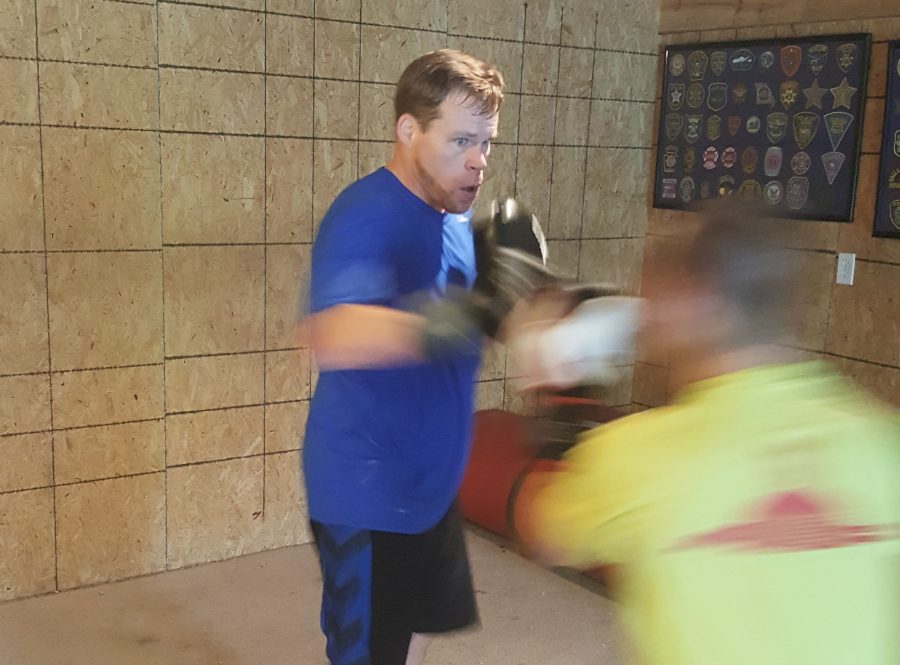 Social Studies teacher David Luers throws a punch at his sparring partner in practice. Luers is starting a club geared toward young women at SHS in order to spread basic knowledge of self-defense.