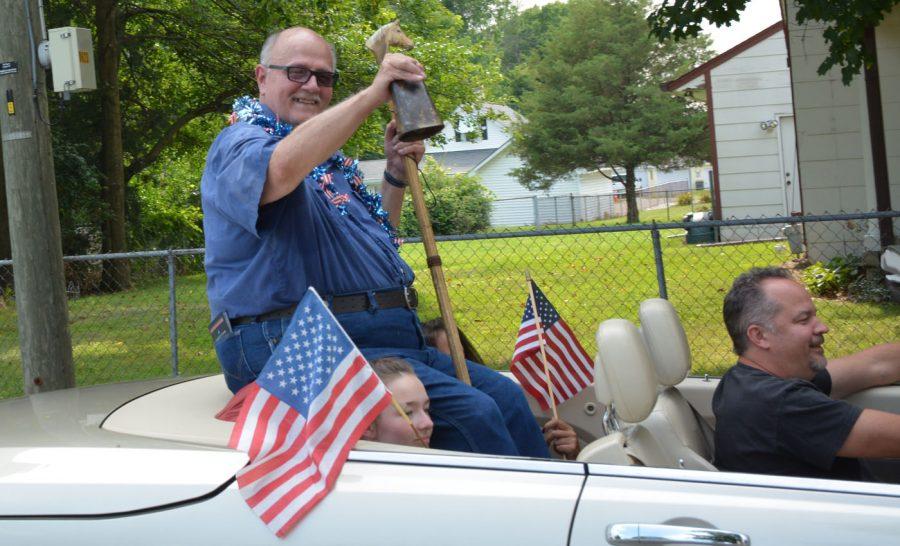 Pete Hildebrand rings a bell in the Fourth of July Parade as Grand Marshal. The history of his family in Southport earned him his title.