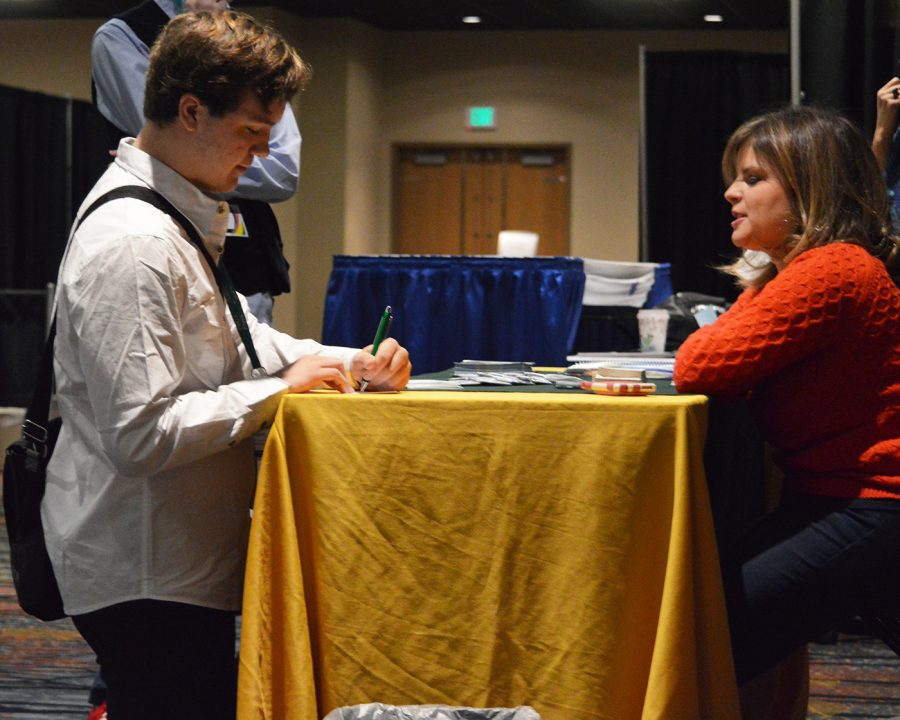 Senior student from Missouri, Charles Roberts, completes a form for information about George Manson University on Nov. 11, 2016 at the JW Marriot in downtown Indianapolis. Several colleges and universities were offering information about journalism and media programs that are offered at their schools.