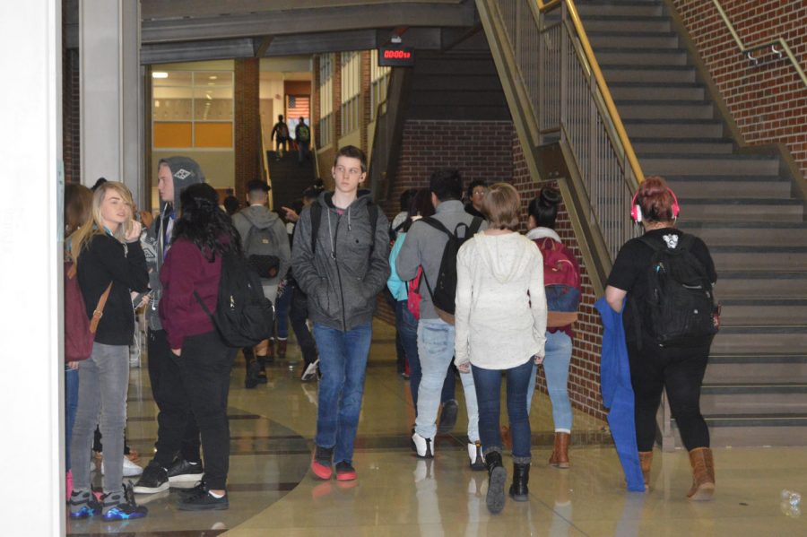 Senior Kaleb Moore walks down the main hallway among other students during passing period on Jan. 12. Moore says he loves the atmosphere of SHS because of his teachers and friends, despite having a tired face during passing periods in the morning. 