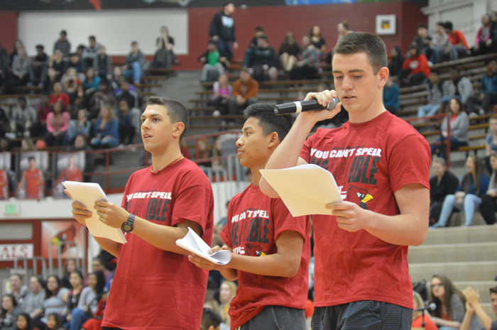 Juniors Dallas Matlock (left) and Josh Thang (middle) listen as junior Scott Rippy (far right) announces the senior athlete during the pep session on April 7. 