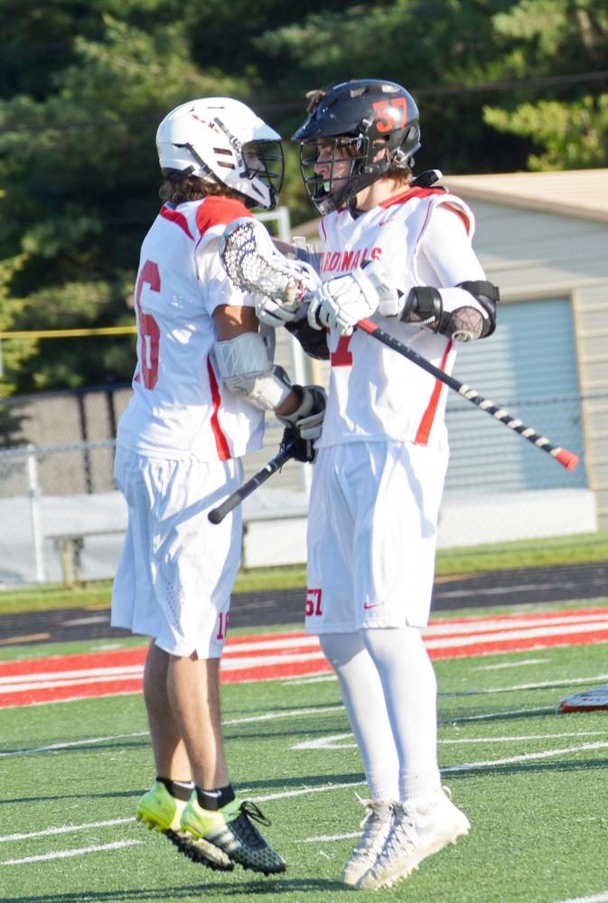 Junior Jacob Tellas and Freshman Isaac Palmer shoulder jump in celebration after scoring a goal. The final score was 11-5, SHS’ loss.