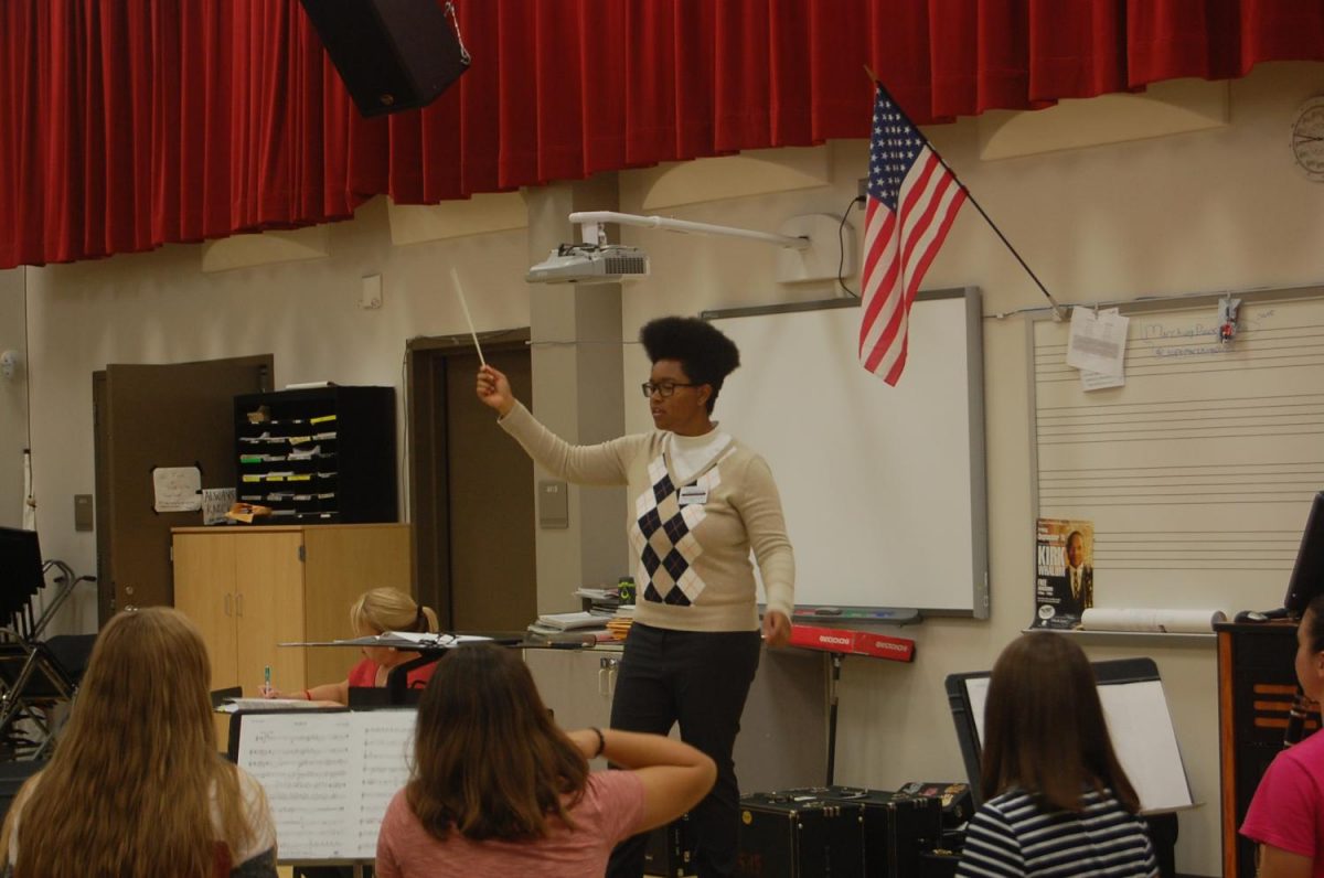 The student teacher,  Giauna Neville,  conducts during band class. She plans on studying Jazz Studies in the future.