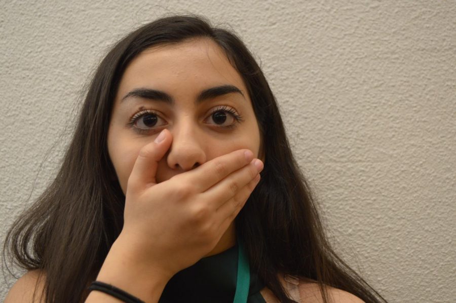 Heritage High School sophomore Maya Aridi poses with her hand over her mouth, representing being censored. 