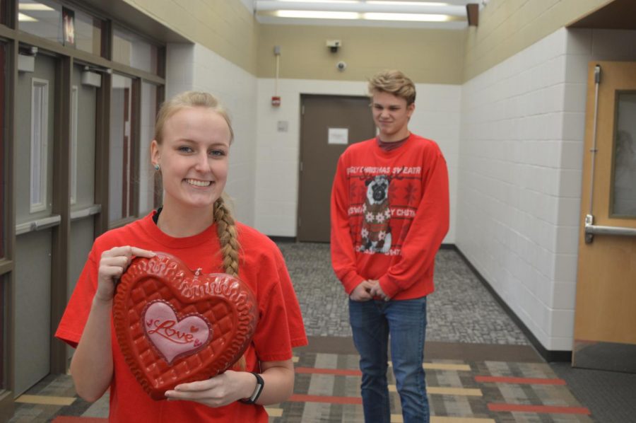 Senior Andrea Bernard poses with her newly-purchased Valentines Day decor that she bought at Target while fellow senior and distraught boyfriend Evan Wilder looks on. Ive given up trying to understand women, Wilder said. 