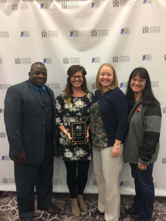 Briana Underwood (second from left) holds her counselor of the year award. She stands with coworkers Lamant Rascoe, Amy Boone and Julie Fierce (left to right).