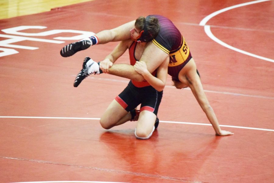 Junior Justin Tracy wrestles an opponent in the conference meet on Jan. 19.