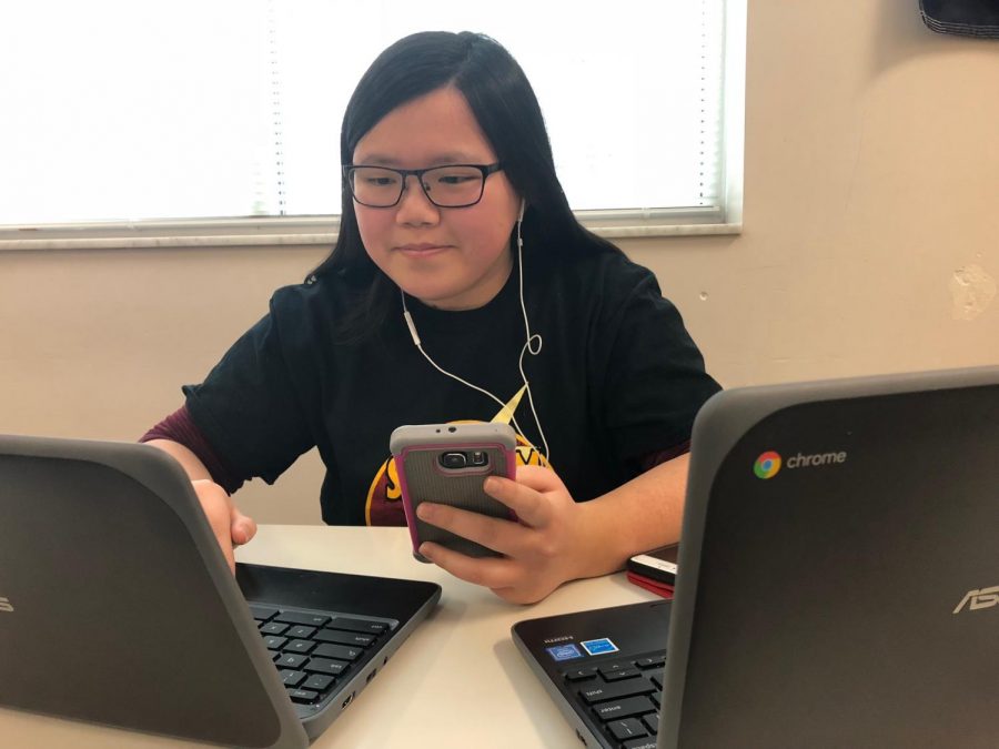 On Jan. 15, Maya Peterson-Womack works on her Chromebook while also on her phone. Peterson-Womack belives that today her and other teens are increasingly using technology. Peterson-Womack says one way she tries to limit her technology use is by studying old-school ways with paper and pencil. 