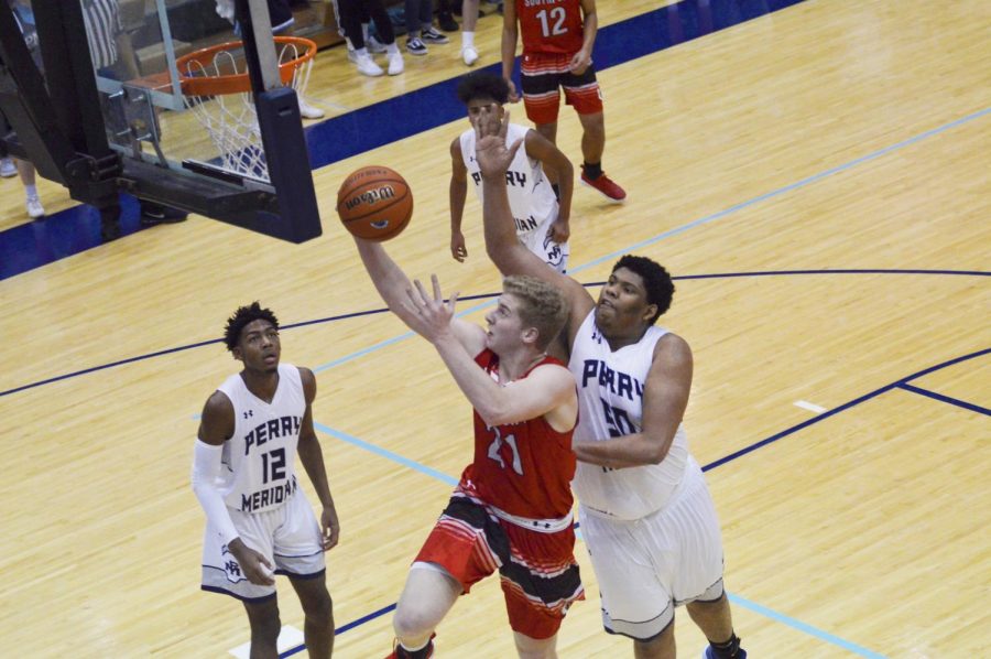 Junior Eddie Schott goes up for a layup during the Perry Meridian basketball game on Feb. 1 at PMHS. Schott led the Cards in scoring with 23 points in their 71-57 victory.