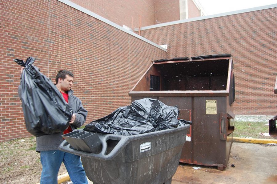 Junior Daniel McDonald takes out the trash during second lunch on Thursday, March 8.