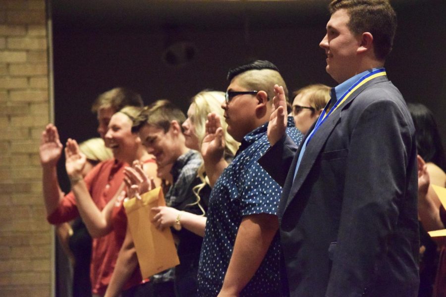 Inductees take the Thespian Society oath at the end of the ceremony on Friday, May 11.
