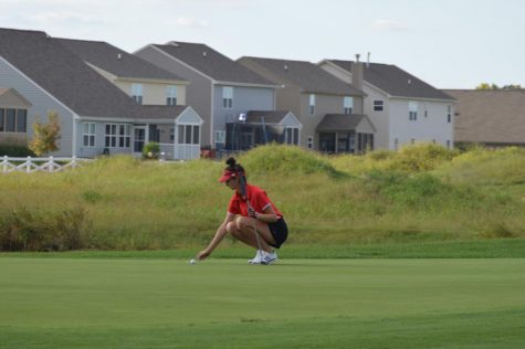 Senior Zoe Ozolins makes a putt during SHSs match against Perry Meridian on Sept. 11.