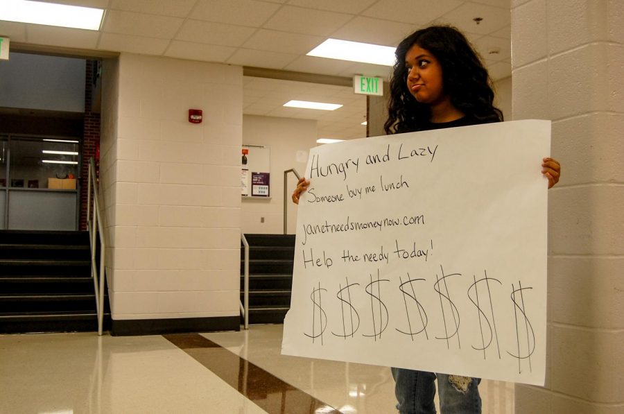 Sophomore Janet Rockefeller stands outside of the cafeteria collecting donations.