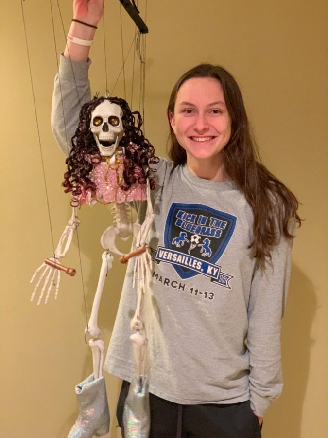Senior Jordan Cox poses with one of the puppets that is used in performances at Peewinkle's Puppet Studio. Cox personally hand-made the puppet shown. 