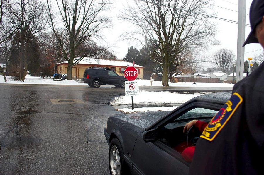 Junior Wha Hek being stopped after turning left out of the student
parking lot on Jan. 14. Signs were
recently installed instructing students
to not turn left out of the lot for safety
reasons.