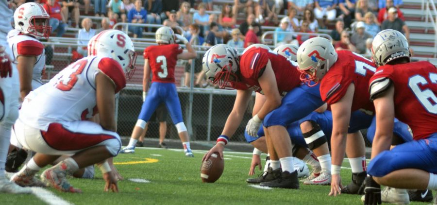 Junior AJ Helton lines up with the rest of the defensive line against the Rebels’ offensive line. Helton was able to push back the Rebels a few yards. Photo by David Masengale
