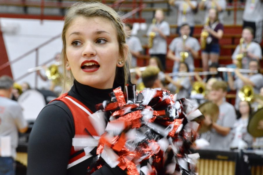 Senior Olivia Scaggs cheers at the pep rally. This year the cheerleaders performed a new dance routine, choreographed by former student Olivia Brite.