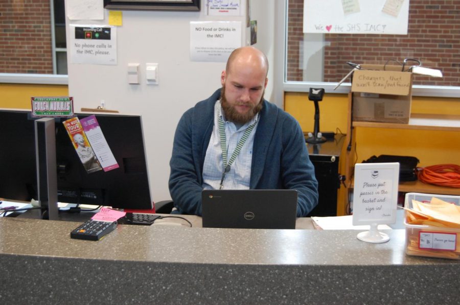 Media Clerk Matt Norris fixes a Chromebook on Nov. 20. Norris began working at SHS at the beginning of the school year.  