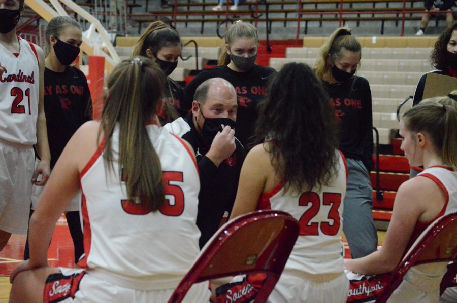 Girls+basketball+head+coach+Adam+Morelock+draws+up+a+play+during+a+timeout.+The+Lady+Cards+will+only+be+allowed+two+spectators+per+player+because+of+new+guidelines.+