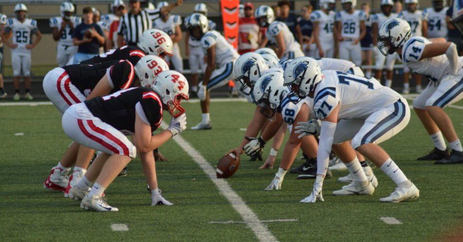 The SHS Cards defensive linemen set up against the PMHS Falcons as they prepare to snap the ball. The Cards lost to the Falcons 42-7 on Aug 27.