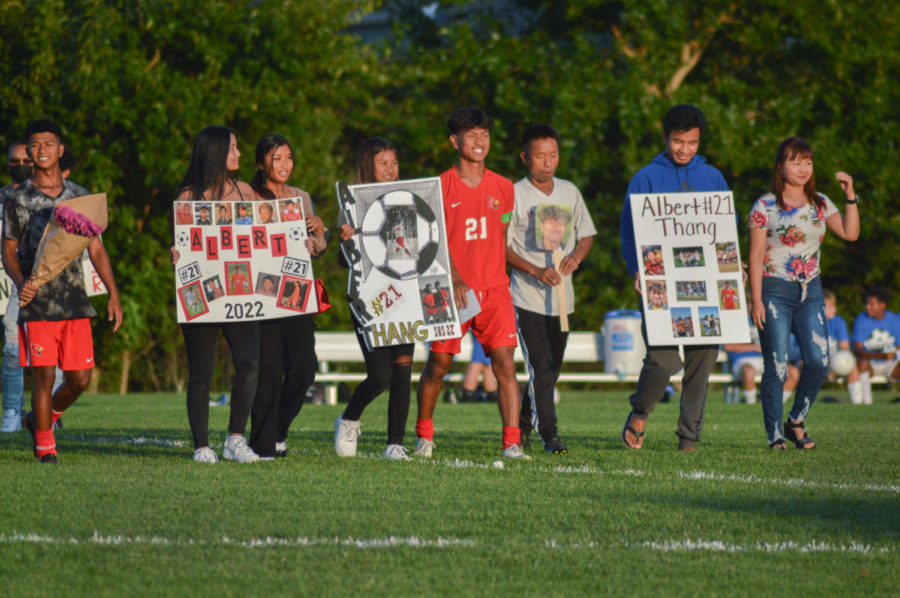 Thang walks out with his family and friends during the senior night ceremony on Sept. 16, before the game against Franklin Central
