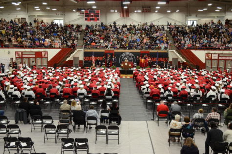 Students sit during the 2021 graduation ceremony. All students will wear red gowns at this years graduation.