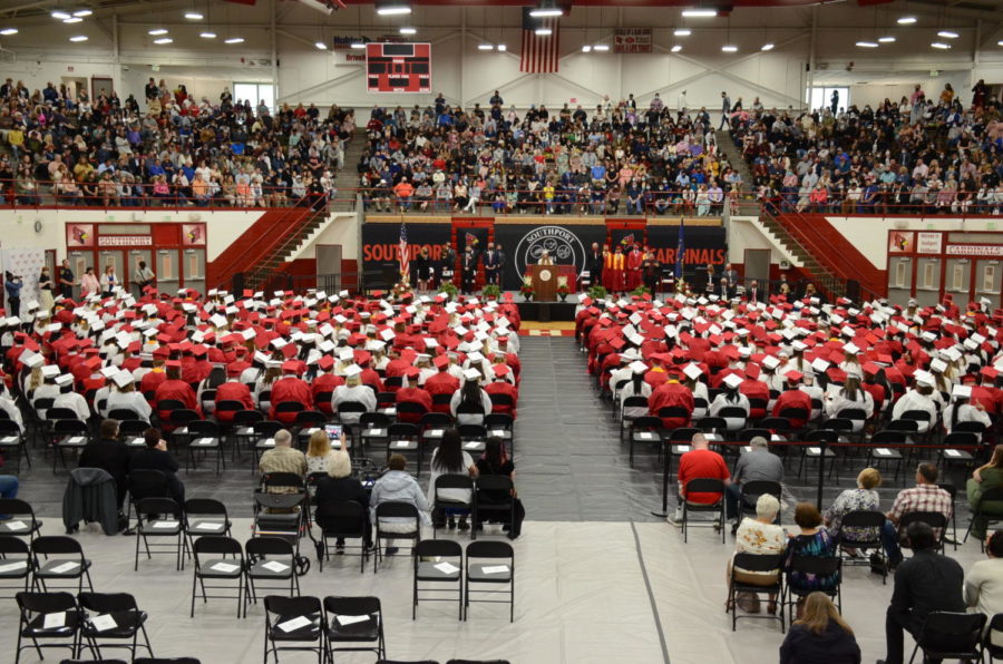 Students sit during the 2021 graduation ceremony. All students will wear red gowns at this years graduation.