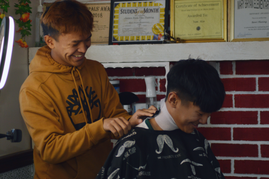Kio cuts his clients hair. Many people go to get their hair cut by him because of his low price. 