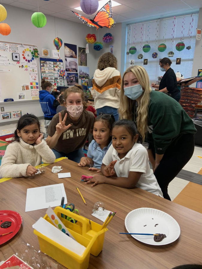 Seniors+Haley+Matlock+and+Audrey+Heaton+help+kids+make+ornaments+during+class.+They+enjoy+being+able+to+do+hands-on+activities+together.+