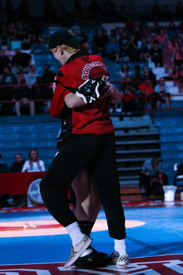Freshman Kyla Johnson and senior Nathan Smith share a  hug after Johnson pinned her opponent to win a girls state title. Johnson will wrestle 113lbs for the Cards at sectionals on Jan. 29.