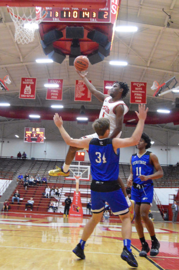 Junior A.J. Dancler drives in for a layup on a Heritage Christian defender. The Cards beat Heritage Christian 45-44 in the Tip-Off Classic on Dec. 11.