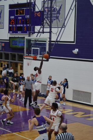 Junior Nickens Lemba blocks a shot in the win over the Falcons on Friday, March 4. Lemba set the single season block record at SHS last Thursday, Feb. 24 and now has 59 blocks on the season.