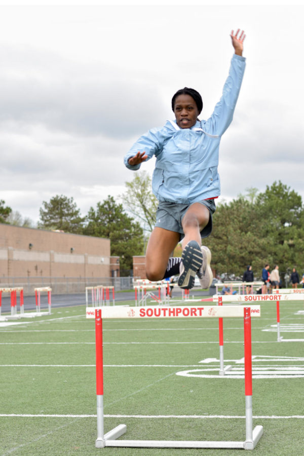 Senior Modupe Awosayna practices 
jumping over hurdles in order to prepare for her next meet. The Cards will compete in the Conference Indiana tournament tonight at Bloomington North.